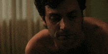 a close up of a man 's face with a tear running down his cheek