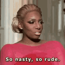a woman in a pink dress is making a funny face and saying so nasty , so rude .