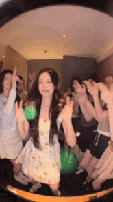 a woman in a white dress is surrounded by other people