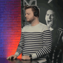 a man wearing headphones and a striped shirt