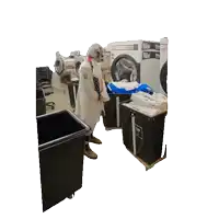 a man in a lab coat is standing in a laundromat looking at clothes