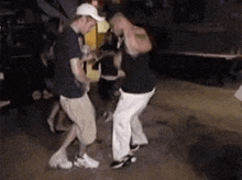 a group of men are dancing on a dance floor in a club .