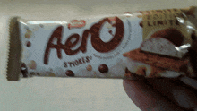 someone is holding a bar of aero smores in their hand