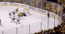a hockey game is being played in front of a banner for geico