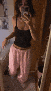 a woman taking a selfie in front of a mirror