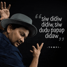 a man wearing a hat is standing in front of a quote by tompi