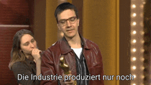 a man holding a trophy with the words die industrie produziert nur noch written on the bottom