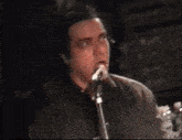 a man singing into a microphone in a blurry photo