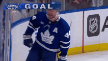 a hockey player in a blue jersey with the number 4 on it