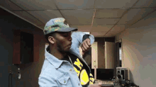 a man wearing a hat and a jacket that says wu tang on it
