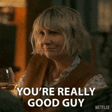 a woman holding a glass of wine with the words you 're really good guy on the bottom