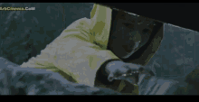 a man in a yellow raincoat is reaching for something in a movie screen shot