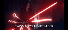 a woman is holding a swiss army light saber in the dark .