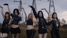 a group of girls are posing for a photo with the letter l on the bottom right