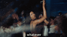 a blurry picture of a woman dancing with the word whatever in the corner