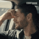 a man in a car with countdown written on the bottom