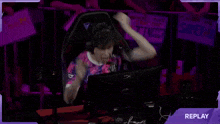 a blurry picture of a person in a purple room with the word replay on the bottom