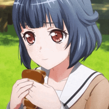a girl with blue hair and red eyes is holding a brown object in her hand