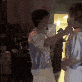a couple of people are standing next to each other in a room .