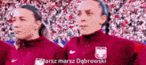 two women standing next to each other with the words marsz marsz dąbrowski on the bottom right