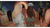 a woman wearing a cowboy hat is standing next to a woman wearing a shirt that says ' mexico ' on it