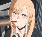 a girl with long blonde hair and a choker is eating a chocolate bar