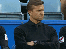 a man in a black shirt with yanmar written on his arm