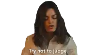 a woman says " try not to judge " in a white shirt