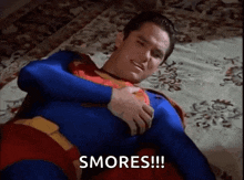 a man in a superman costume is laying on a bed with the words smores !!! above him