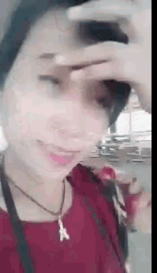 a close up of a woman covering her face with her hand