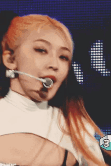a close up of a woman singing into a microphone .