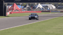 a gray audi is driving on a track