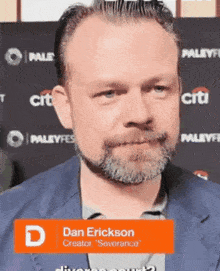 a man with a beard is standing in front of a citi sign