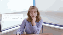 a woman sits at a desk in front of a sign that says ' circles '