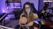 a woman sitting in front of a computer with a waffle in front of her and the name p90princess on the bottom right