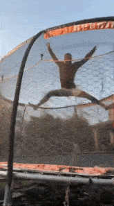 a man is jumping on a trampoline with his arms outstretched