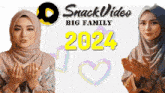 a woman in a hijab praying next to a sign that says snack video big family 2024