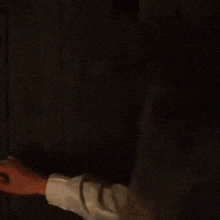 a man in a black robe is standing in a dark room and asking how 's it going .