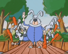 a group of rabbits are standing on a wooden bridge with carrots