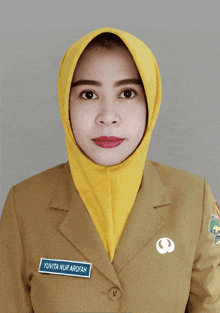 a woman with a name tag that says yuvita nur arofah on it