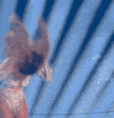 a woman in a bodysuit with her arms up