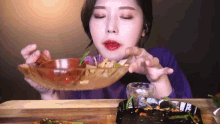 a woman is eating food from a bowl and a plate .