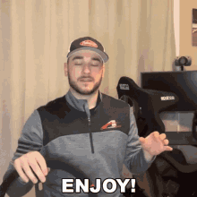 a man is holding a controller with the words enjoy written on it