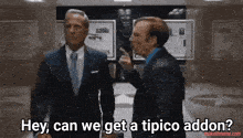 two men in suits are standing next to each other and one of them says hey can we get a tipico addin
