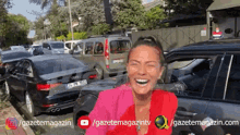 a woman in a pink jacket is smiling in front of a parking lot