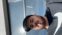 a man smoking a cigarette with his eyes closed