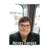 a man wearing glasses is taking a selfie with the caption " never forget "