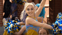 a group of cheerleaders are cheering with their arms in the air