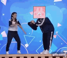 a man and a woman are dancing on a stage with a bunny on their faces .