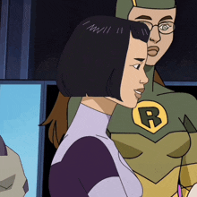 a woman in a purple and green superhero costume with the letter b on her chest